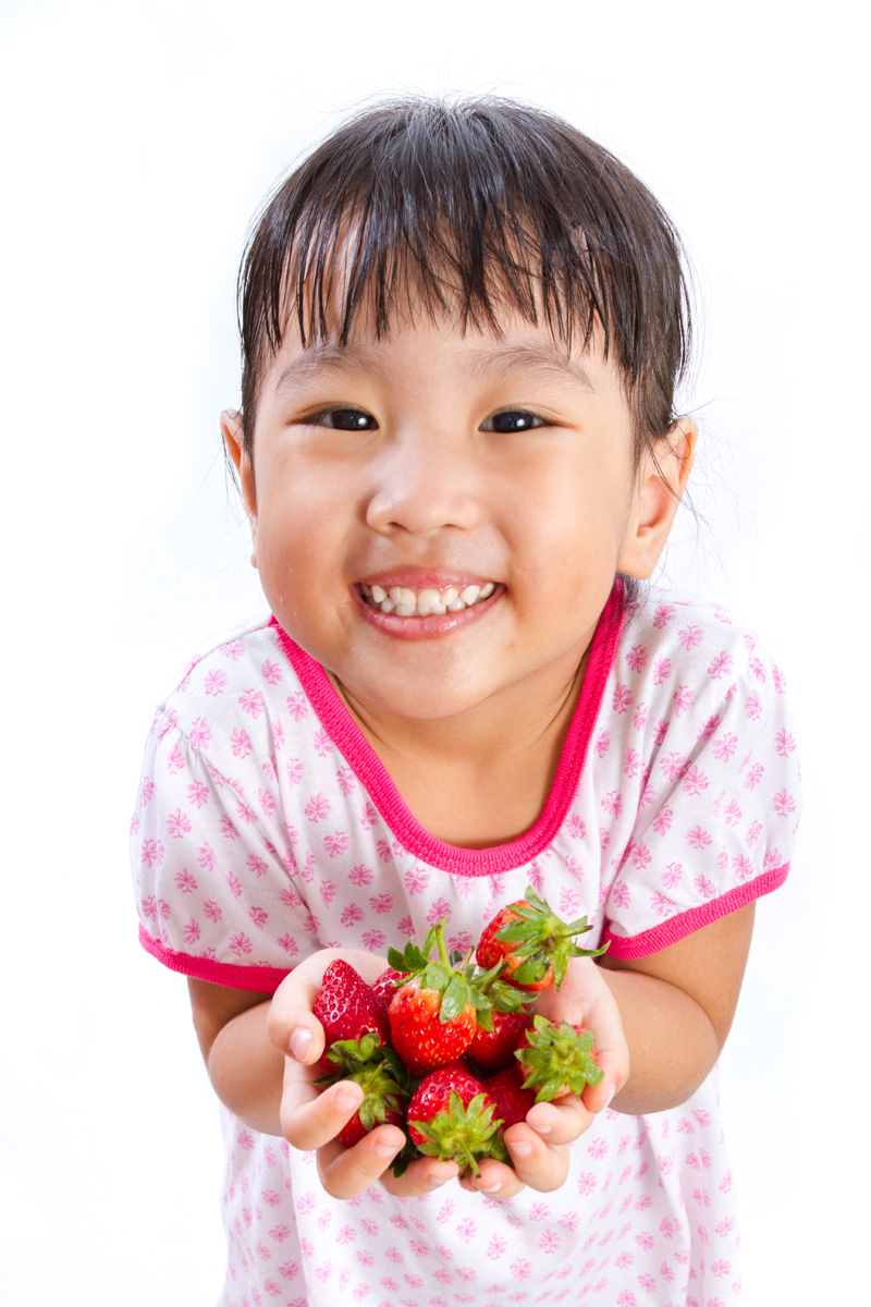 Cute girl with strawberries